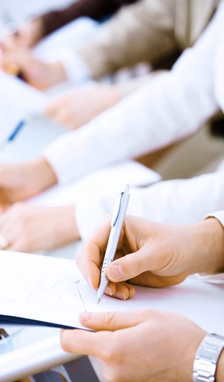 Writing notes Business people sitting in a row and writing notes. Close-up of writing hands. Browse my portfolio for horizontal version.